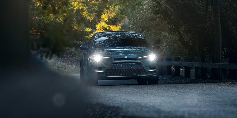 A gray car driving on the road.