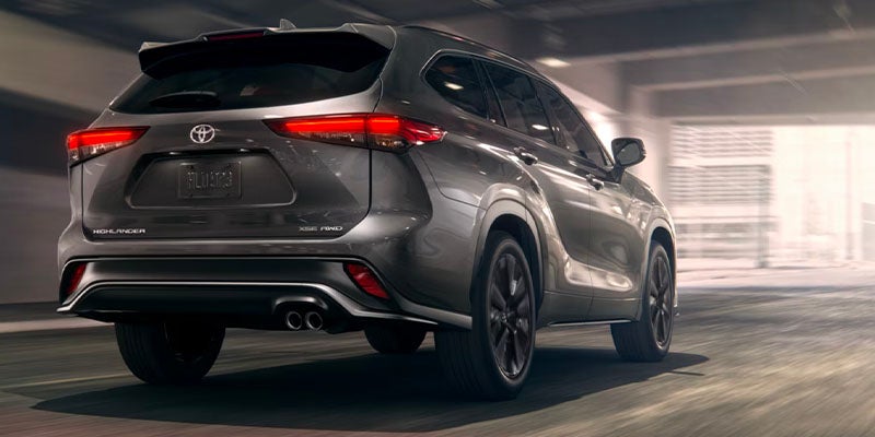 A silver suv driving on the road.