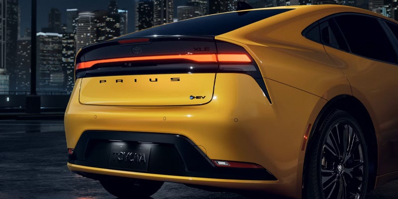 The back end of a yellow prius.