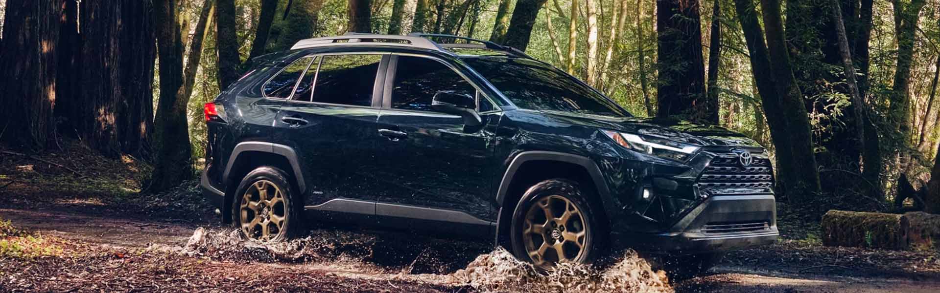 A blue suv sitting parked.