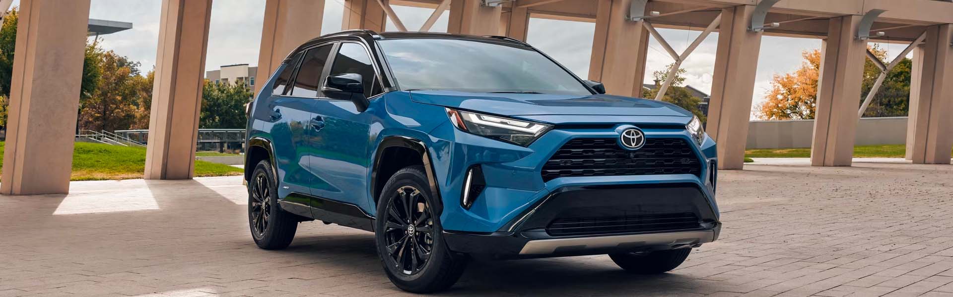 A blue suv sitting parked.