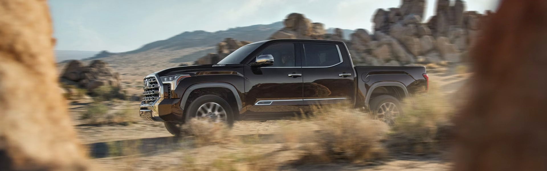 A brown truck driving off-road.