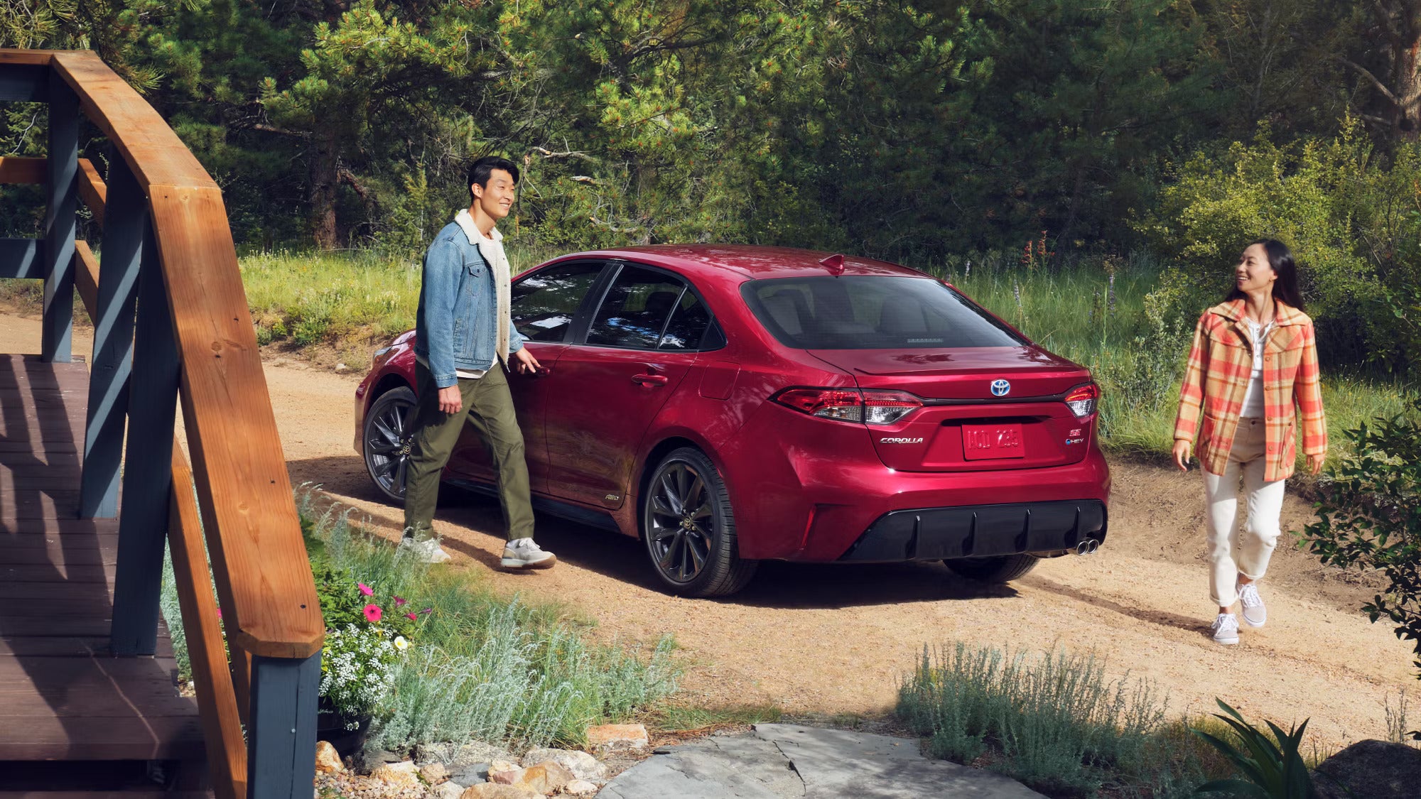 A red car parked in a driveway.