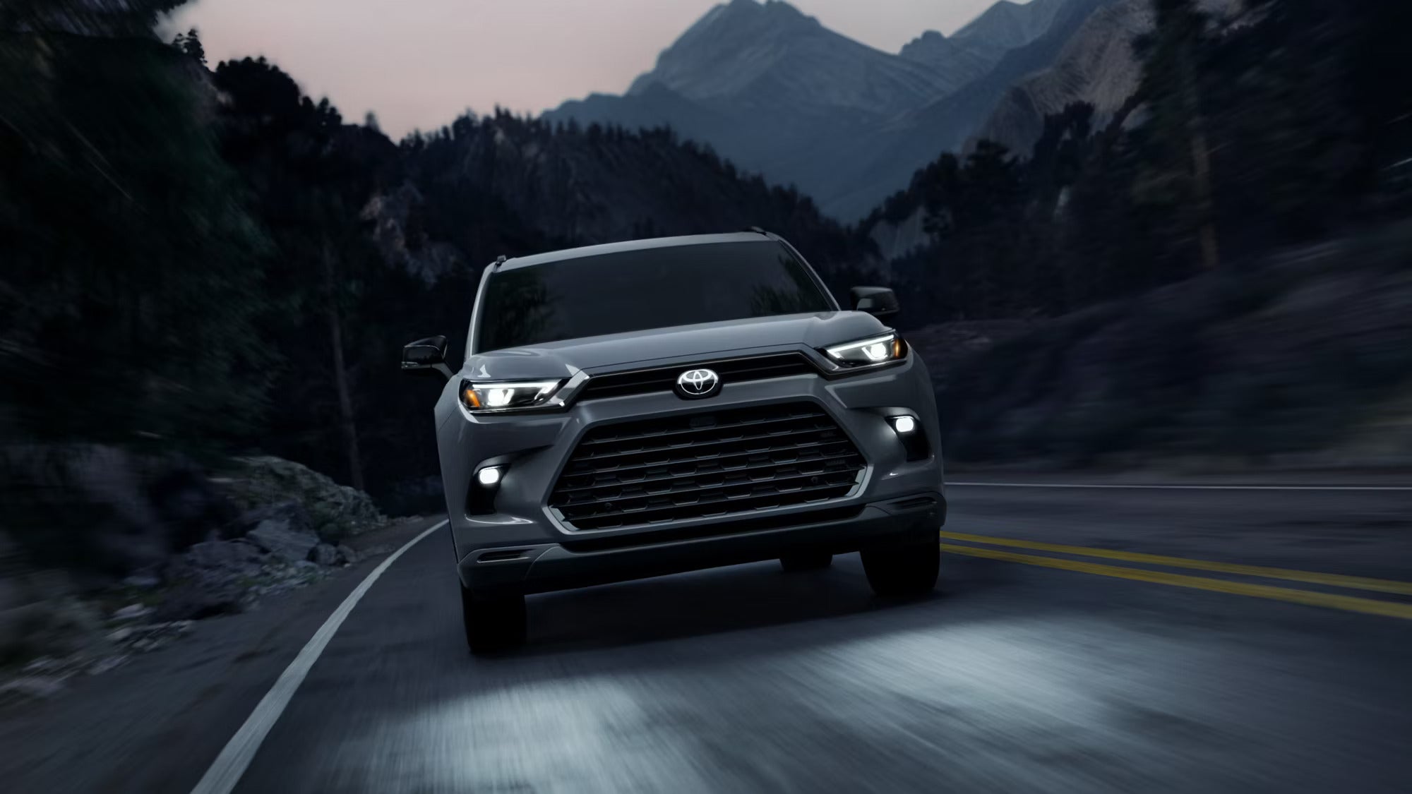 A gray suv driving on the road.