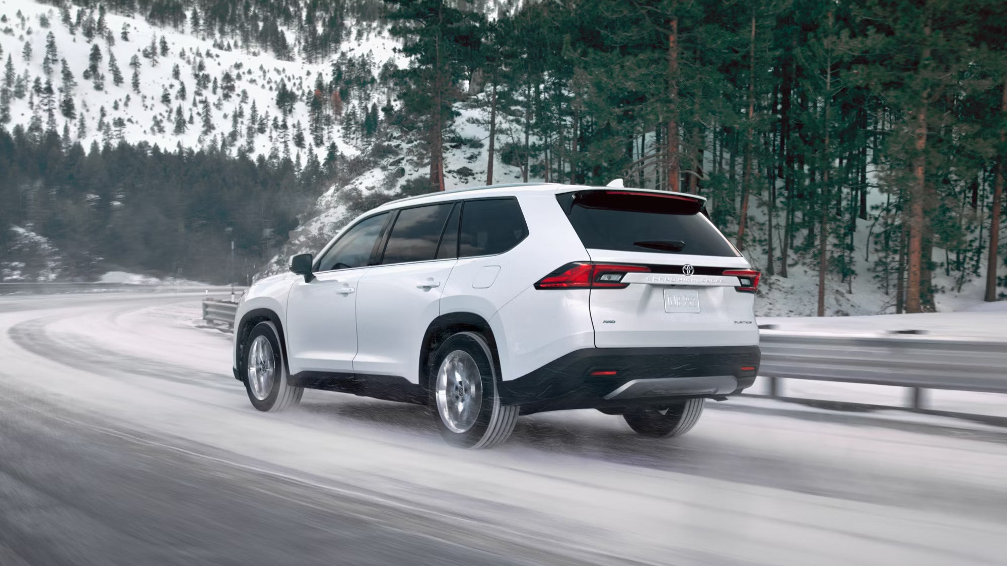 A white suv driving in the snow.