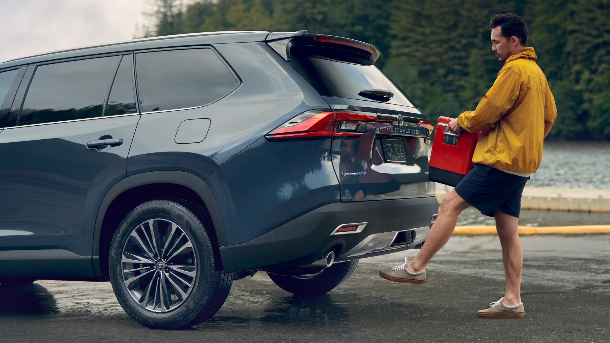 A man putting something into the back of a suv.