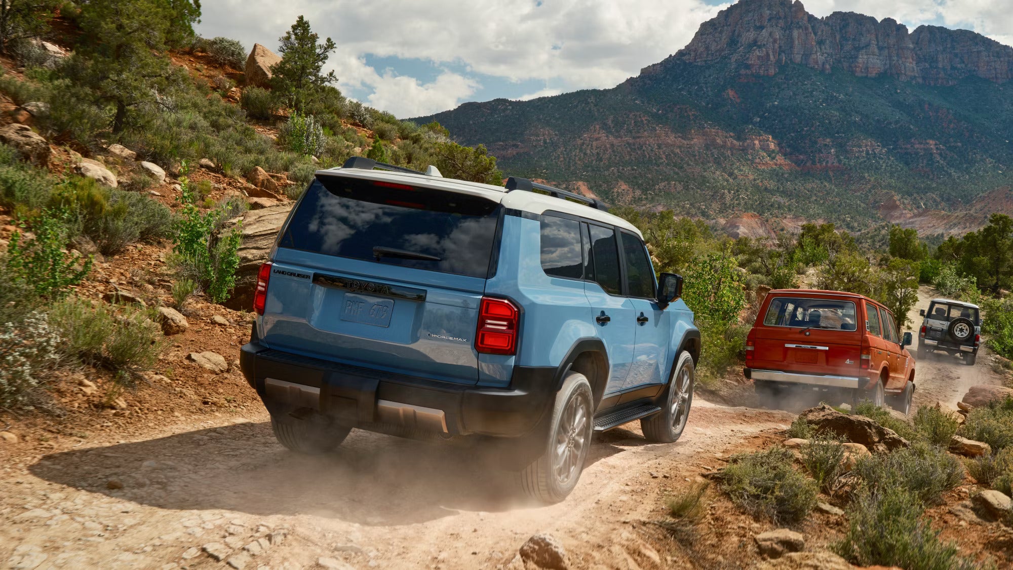 A blue suv driving off-road.