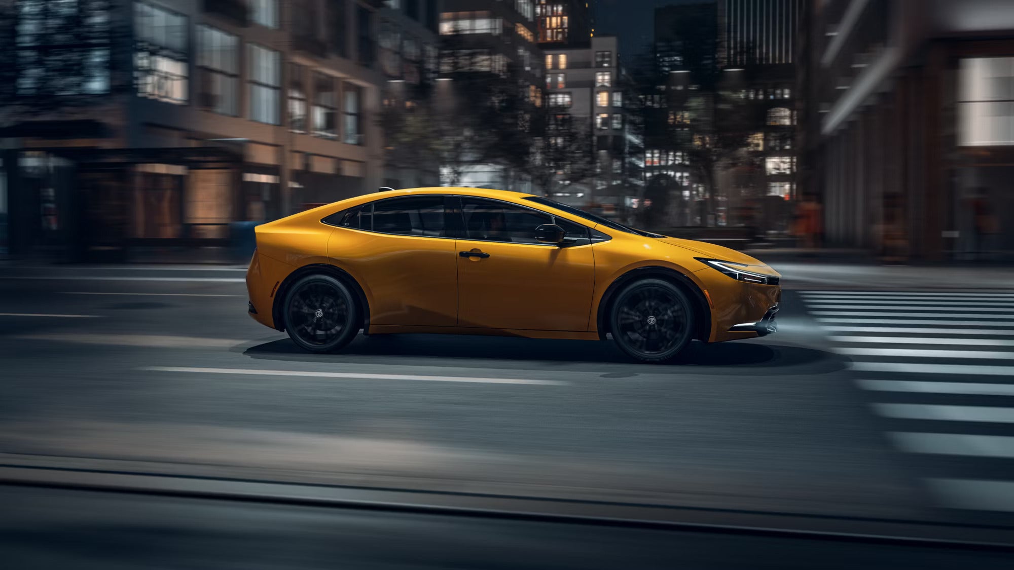 A yellow car driving on the road.