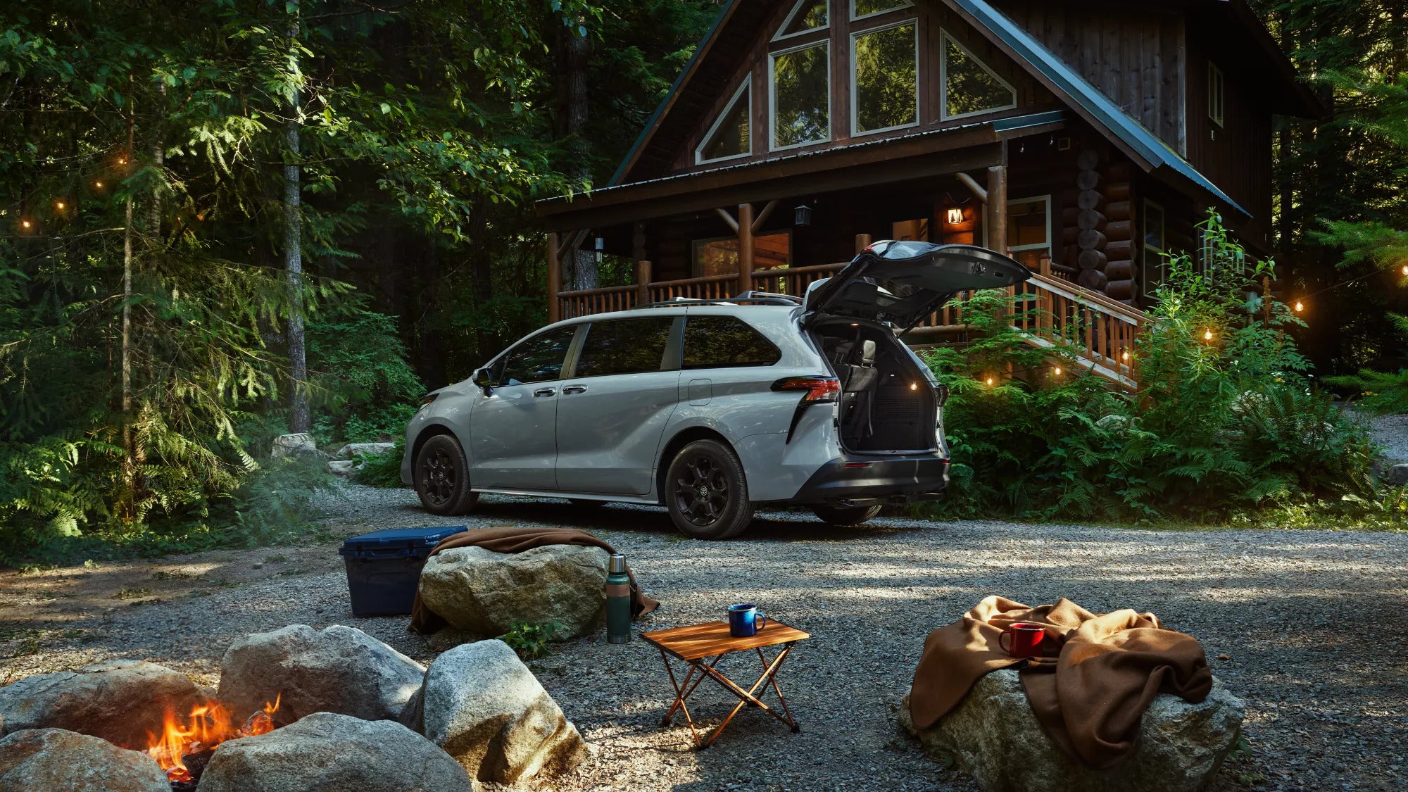 A gray suv parked in front of a house.