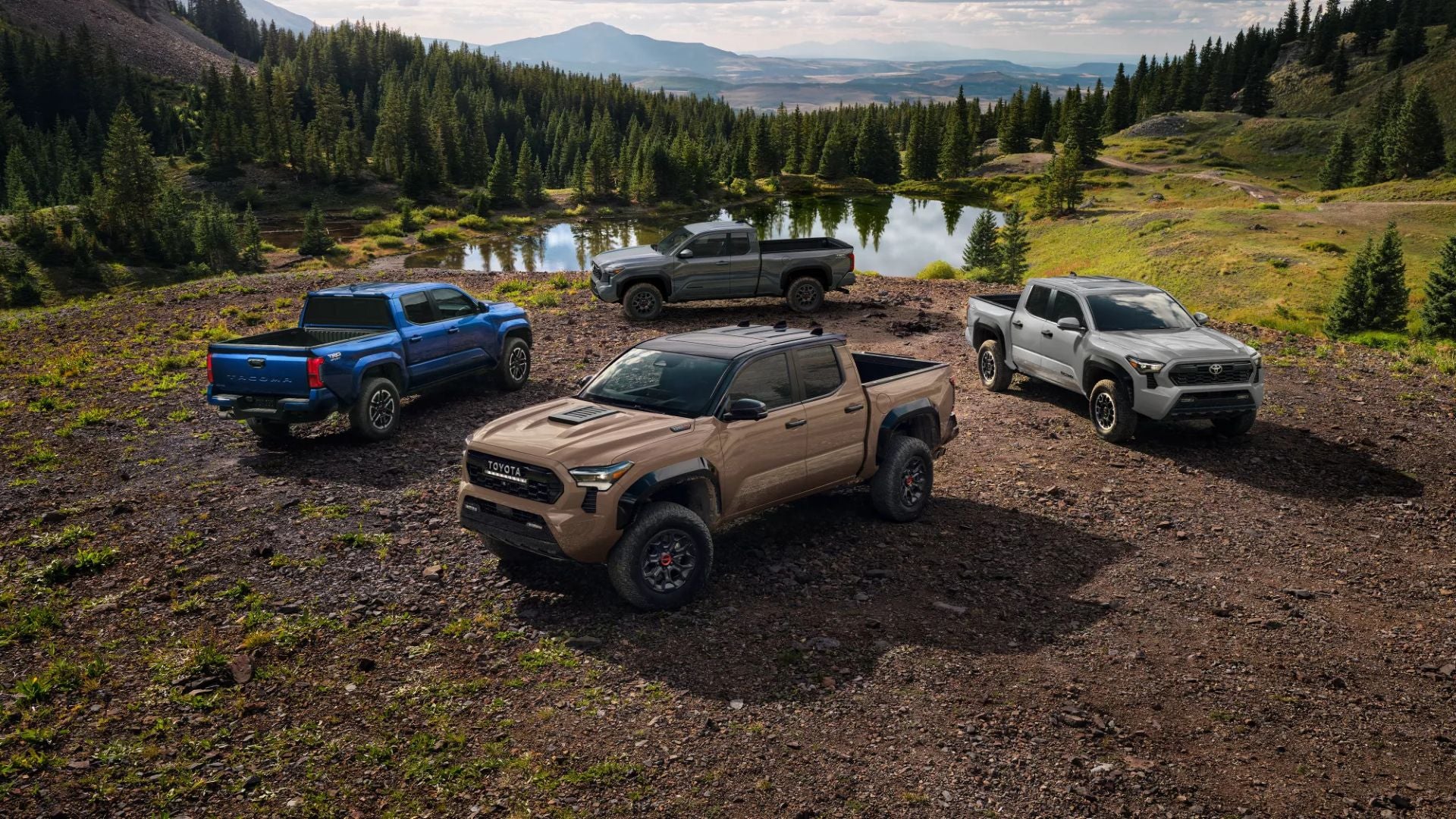 A group of truck sitting parked in front of some water.