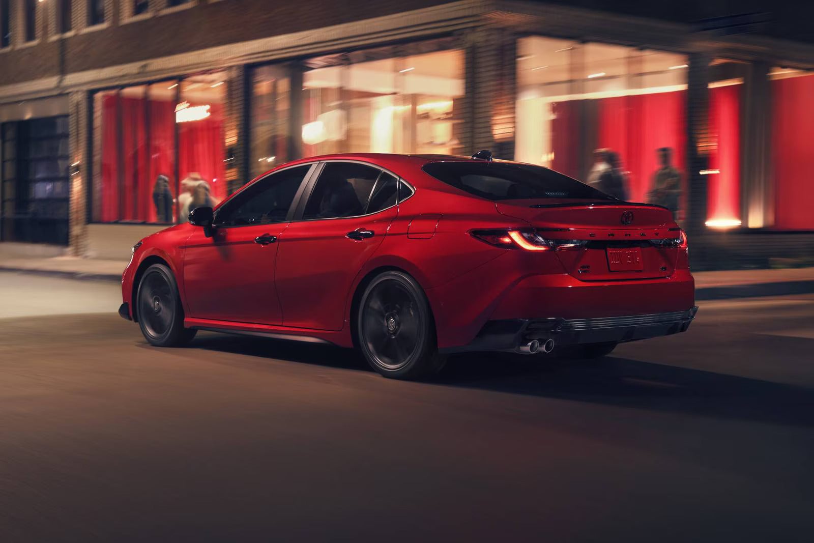 A red car driving on the road.