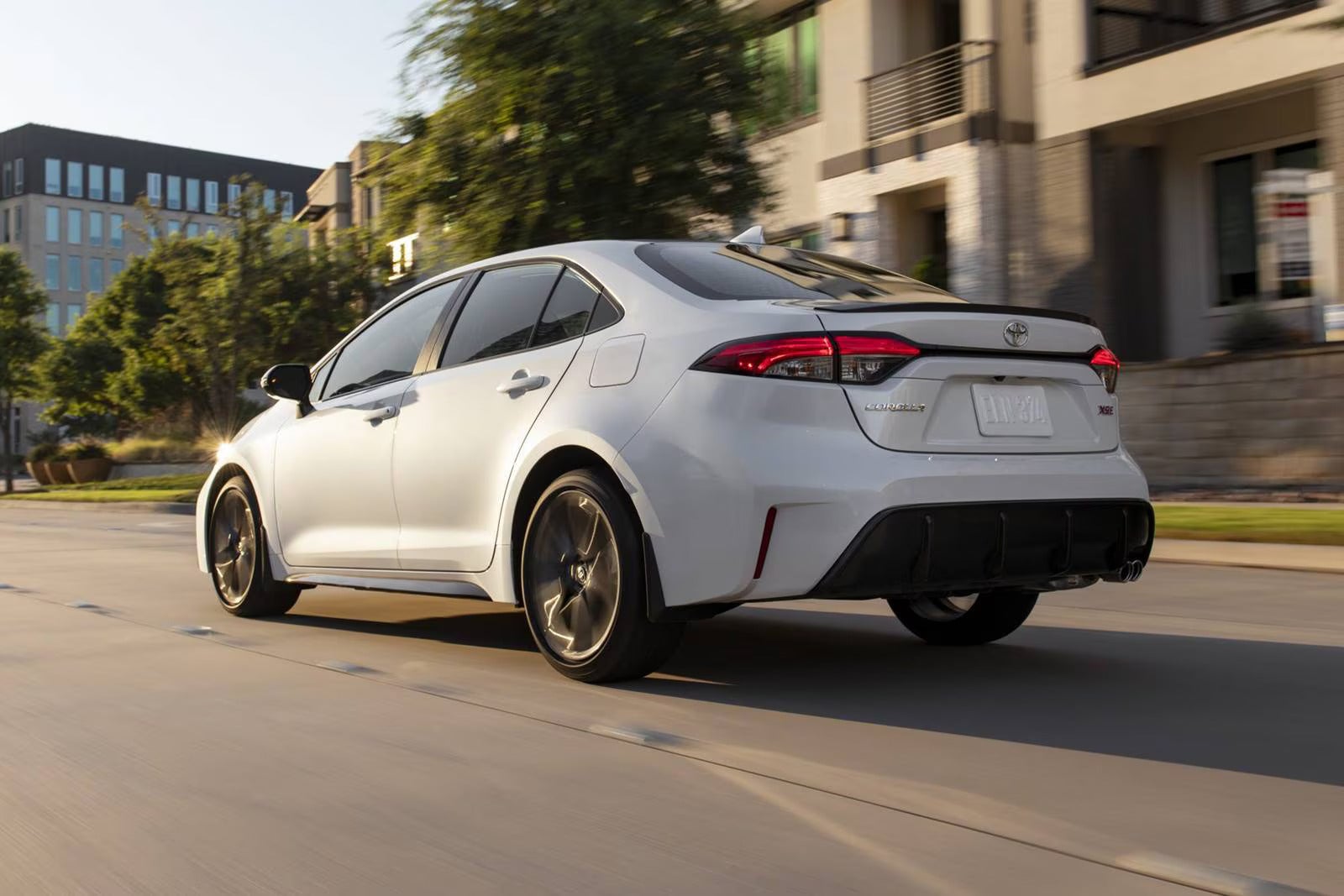 A white car driving on the road.
