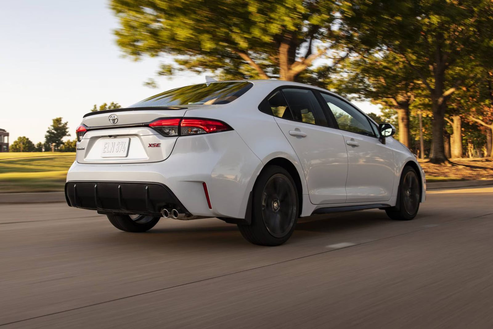 A white car driving on the road.