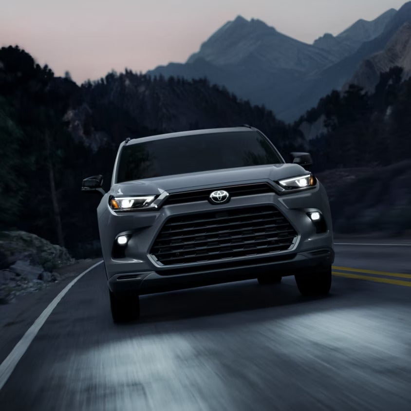 A gray suv driving on the road.