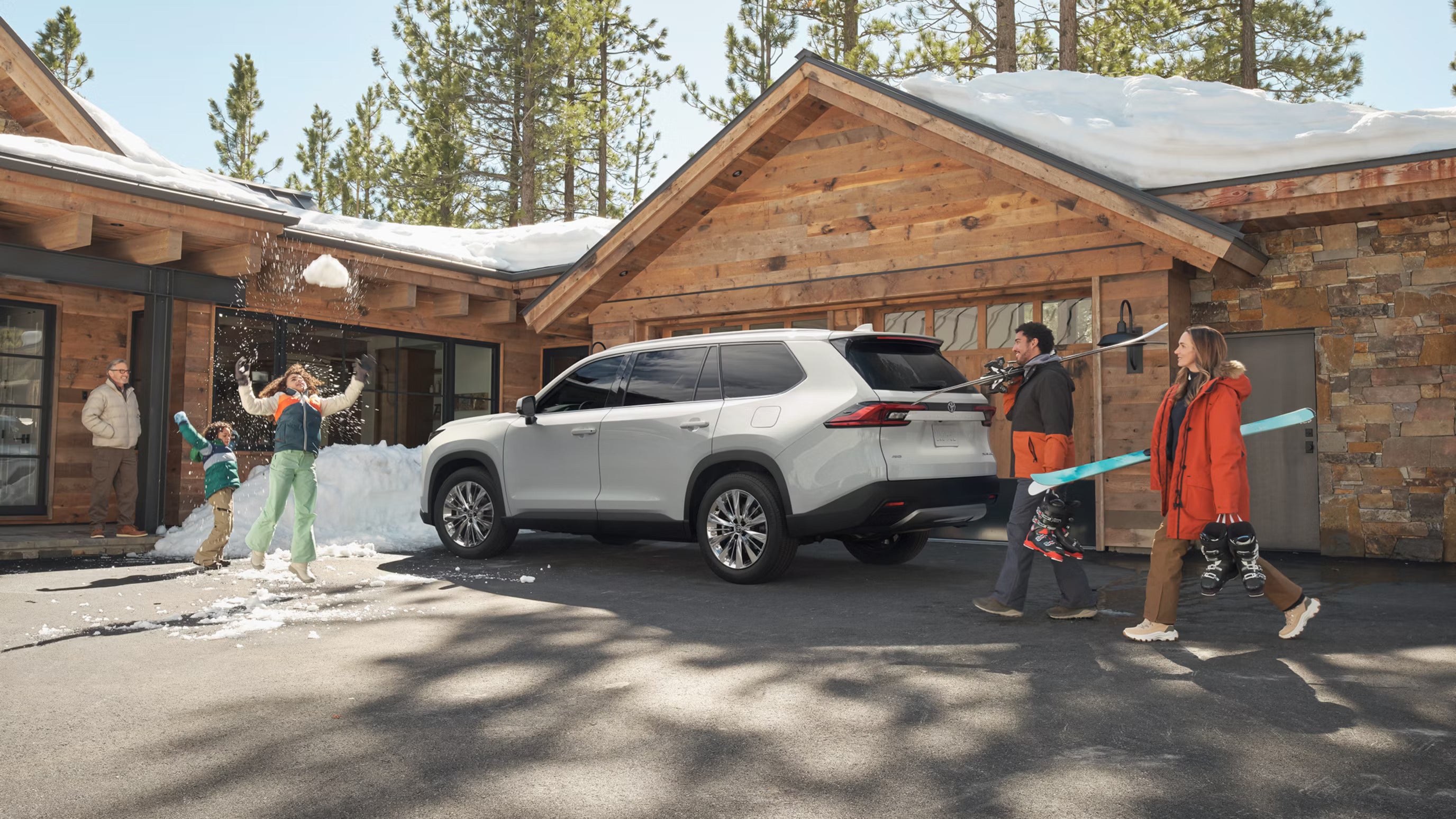 A family walking around a white suv.