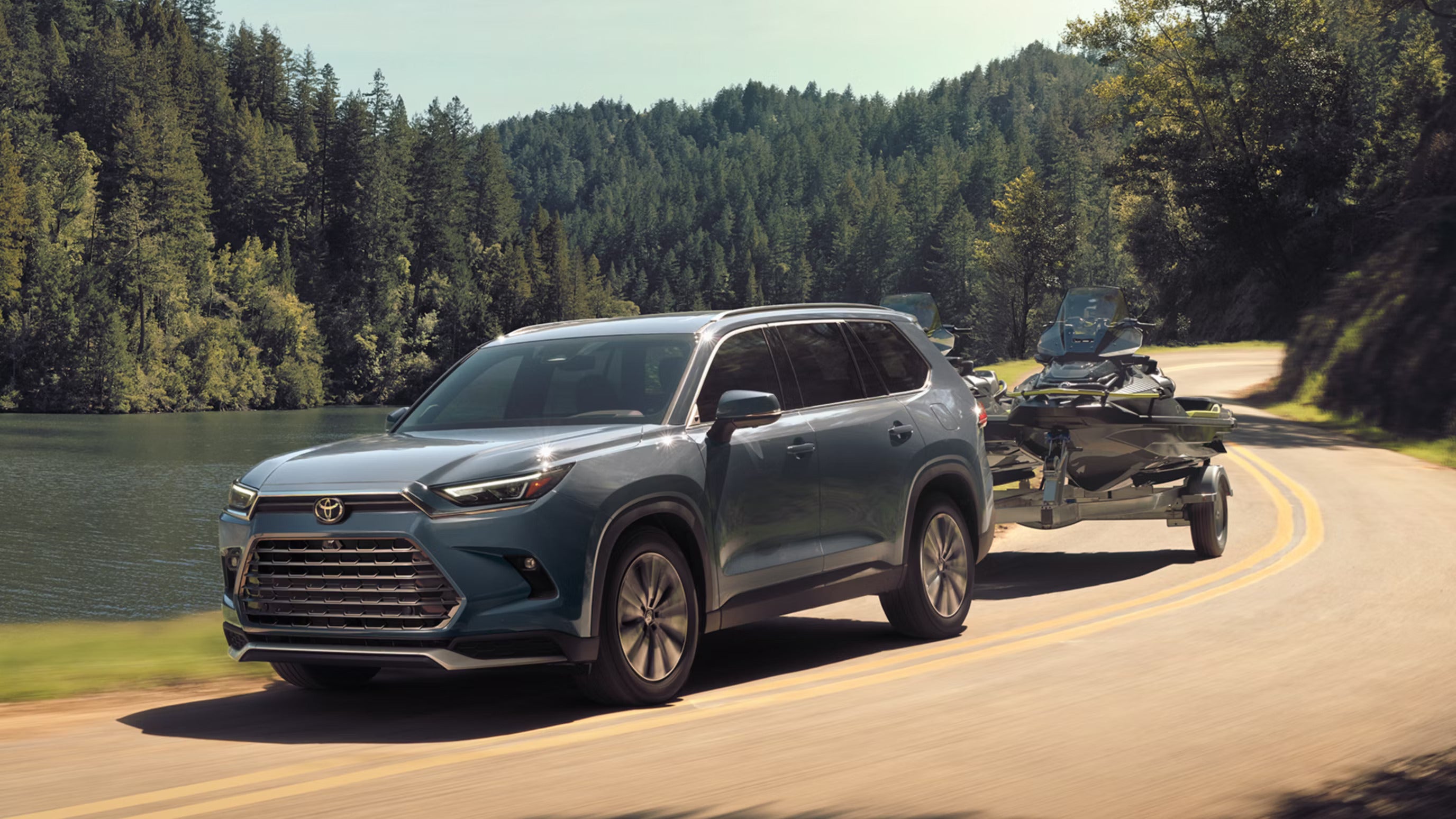 A blue suv pulling a trailer.