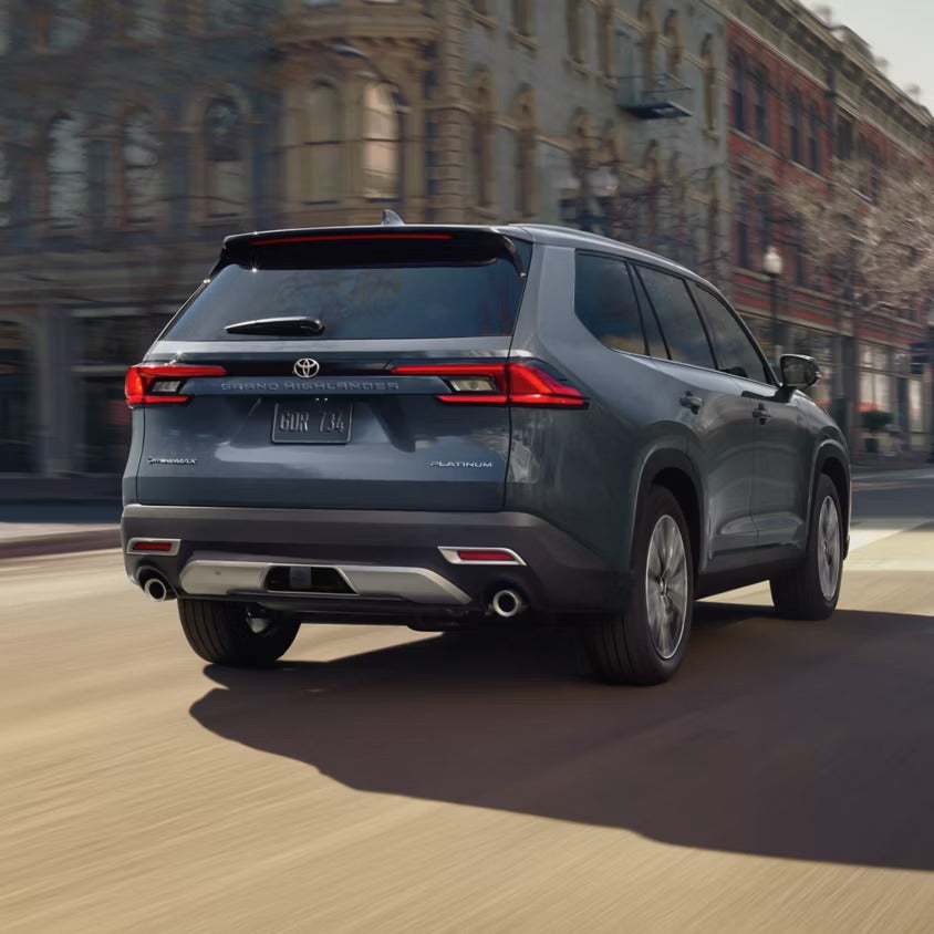 A blue suv driving on the road.