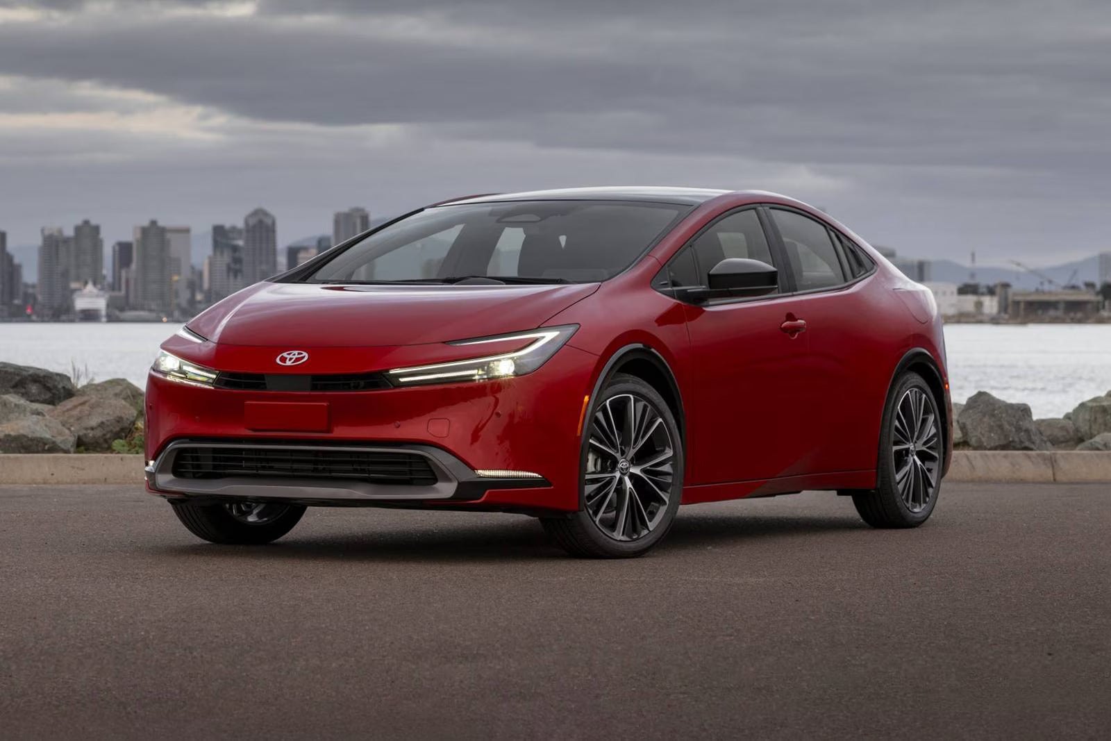 A red car sitting in the road.