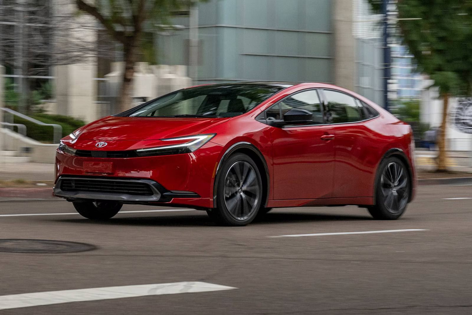 A red car driving on the road.