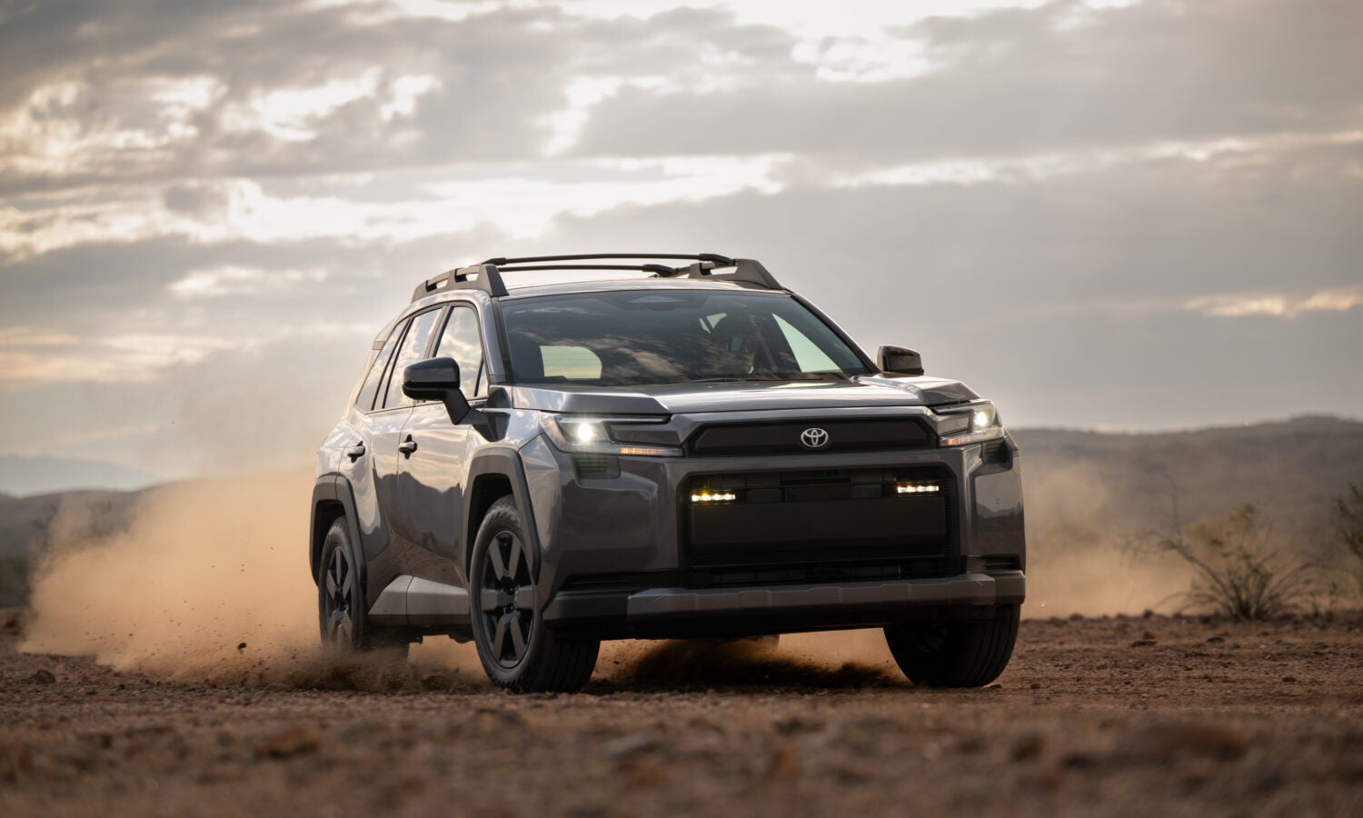 A gray suv driving off-road.