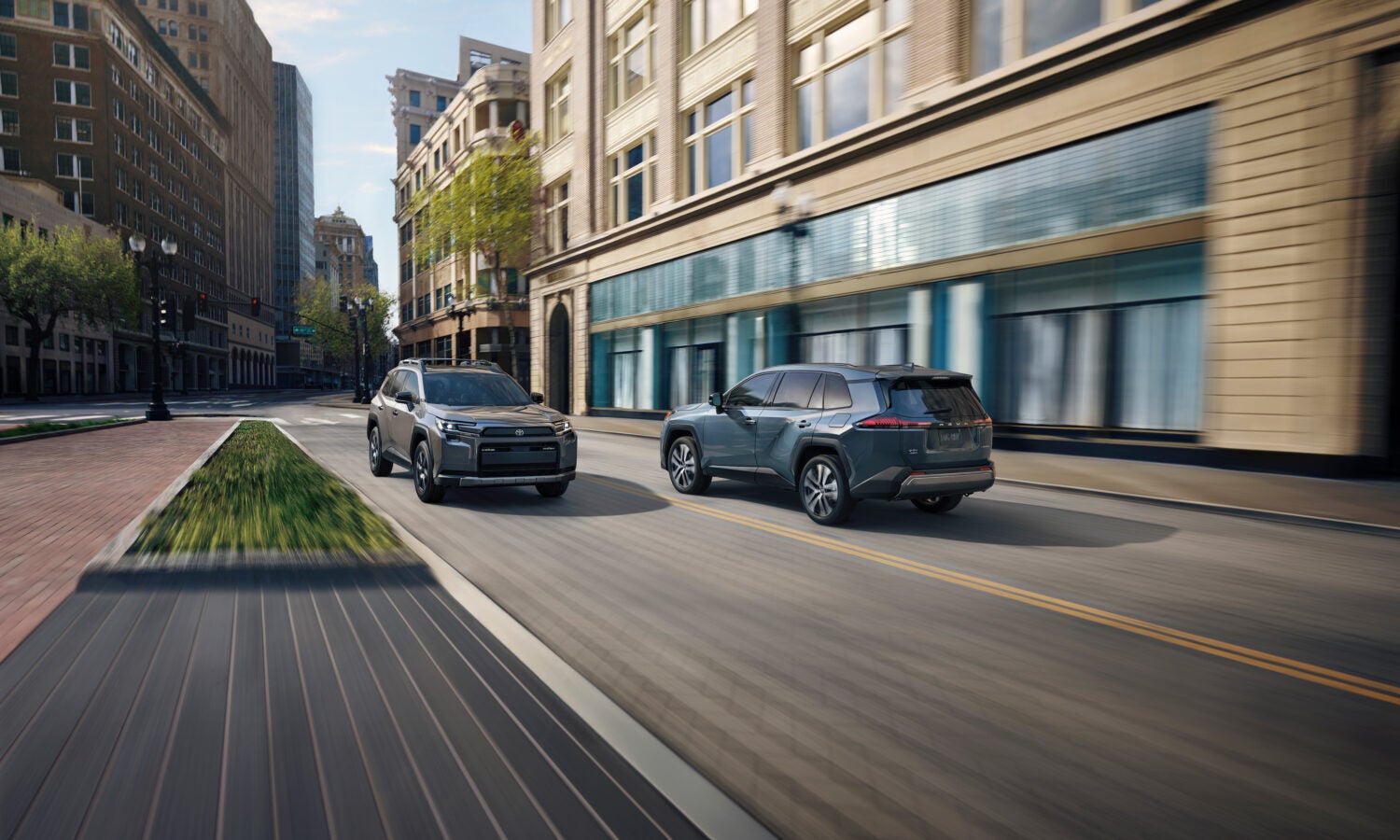 Two suvs driving on the road.